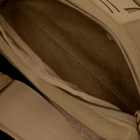 Close-up view of the Condor Draw Down Waist Pack Gen III in tan, showing its tactical fabric interior, visible zipper, and strap.